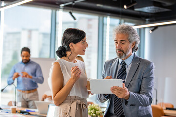 Professional Business Meeting With Colleagues Using Tablet Device