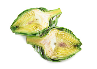 Two halves of ripe green artichokes on a white background