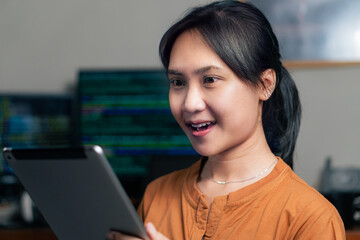 Young Woman Using Tablet in Tech Environment