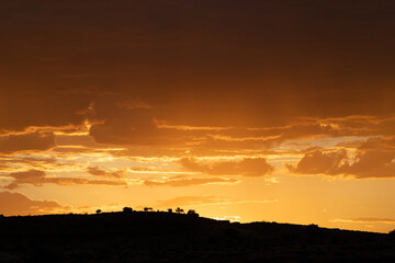 Fototapeta premium A stunning sunset over a ridge in silhouette.