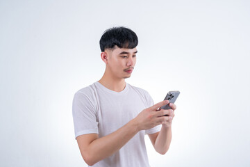 Fototapeta premium Handsome Asian man using smartphone on white background. Concept for advertising, finance business, communication, technology advancement and online shopping.