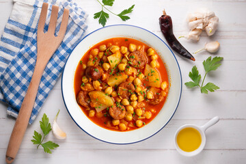 Delicious dish of braised chickpeas with spicy chorizo. Top view food table.