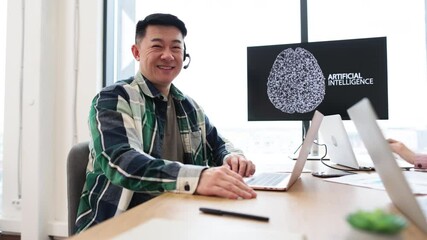 IT expert working on developments of artificial intelligence in modern office setting, giving thumbs up. Professional tech workspace with laptops, smartphone, and digital display showing AI concept. - Powered by Adobe