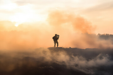 War photographer capturing footage amidst dust and smoke.