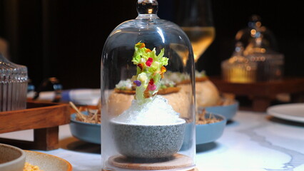 Artfully plated gourmet dish served under glass cloches in fine dining restaurant, emphasizing elegance and exquisite culinary presentation, with soft focus on background. Fine Dining and Culinary Art