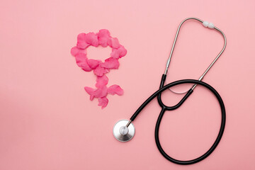Medical Stethoscope and Pink female Petal symbol on Pink Background
