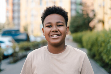 Fototapeta premium Happy african american teenager smiling outdoors
