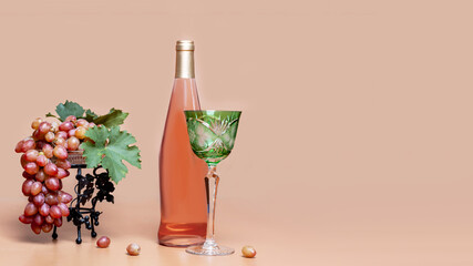 Pink wine and pink grapes in a vase on background with copied space for text.