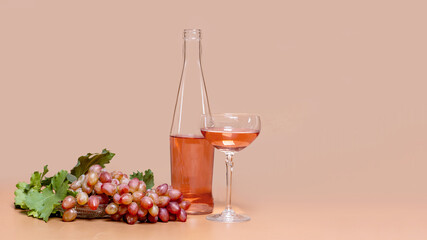 Pink wine and pink grapes in a vase on background with copied space for text.