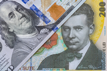 100 dollar banknote and 200 Romanian Lei banknotes