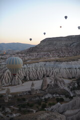 Beautiful view of hot air balloons floating in the air at sunrise with clear sky in Cappadocia, Turkey (Türkiye)