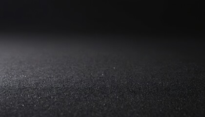 Black textured surface with a slight gradient from dark to lighter grey.