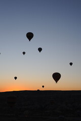 Beautiful view of hot air balloons floating in the air at sunrise with clear sky in Cappadocia, Turkey (Türkiye)