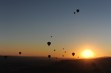 Beautiful view of hot air balloons floating in the air at sunrise with clear sky in Cappadocia, Turkey (Türkiye)