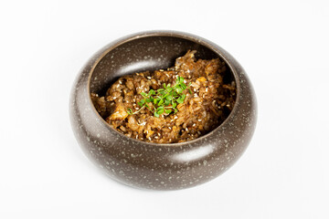 Bowl of buckwheat porridge on a white background