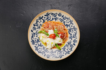 Italian pasta with cherry tomatoes, burrata, and fresh basil - gourmet dish for food lovers