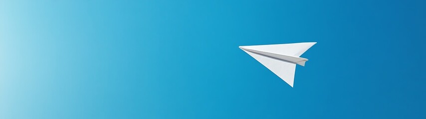 Serene Paper Airplane Soaring in Azure Sky - Minimalistic Low-Angle Shot