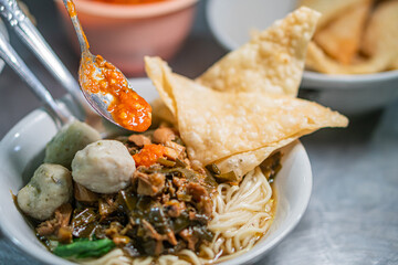 Delicious Noodle Bowl with Meatballs and Spicy Sauce