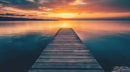 Obraz premium wooden pier over calm water at sunset peaceful landscape serene nature reflection tranquil evening outdoor scenery with beautiful horizon view and sunset reflections