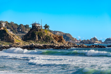 Small rustic summer cabins on the summit of a rock in the town of Quintay, Valparaiso Region, Chile