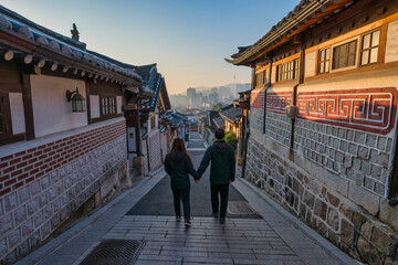 Seoul South Korea sunrise of Korean traditional house at Bukchon Hanok Village with lover couple tourists