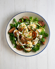 Roasted cauliflower salad with vegetables and yogurt sauce. Top view table.