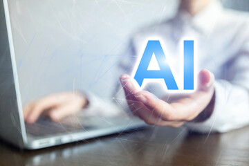 A person is holding a laptop and the word AI is displayed on the screen