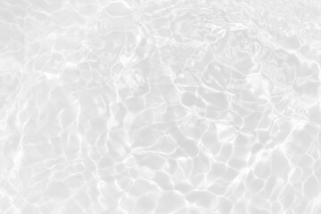 White water with ripples on the surface. Defocus blurred transparent white colored clear calm water surface texture with splashes and bubbles. Water waves with shining pattern texture background.