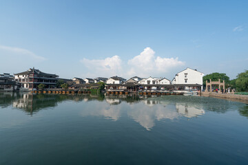 Tranquil Reflection of Traditional Architecture by the Water