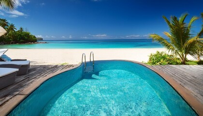 Fototapeta premium Tranquil poolside scene overlooking a pristine tropical beach with crystal-clear turquoise water