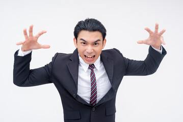 A frustrated young asian business executive wanting to put his hands on someone. Trying to scare a subordinate. Isolated on a white background.
