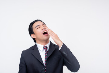 A young asian business executive smiling while yawning. Mocking someone as a boring person. Isolated on a white background.