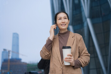 Confident Woman Engaging in Conversation with Coffee in Modern Urban Setting
