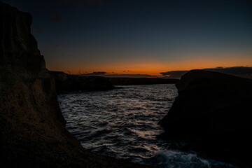 The sky is dark and the sun is setting. The water is calm and the sky is filled with clouds © AlbertoRodriguez