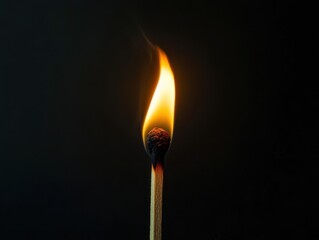 Solitary Flame: Minimalistic Burning Matchstick in Dramatic Light and Shadow