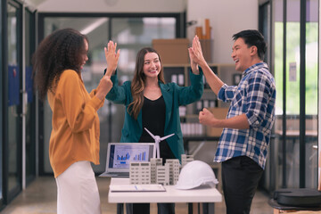 Concepts for housing development and renewable energy A team of industry engineers collaborates at a renewable energy conference working on innovative and efficient solar panel batteries.