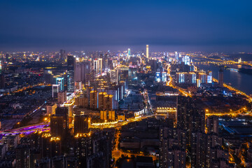 Fototapeta premium Stunning Nighttime Cityscape: Illuminated Skyline with River View