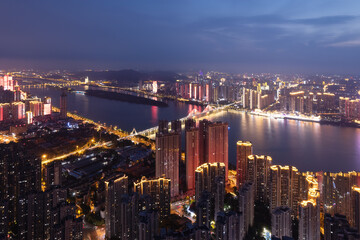 Fototapeta premium Stunning Night Skyline Overlooking a Vibrant City River