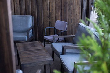 Cozy Outdoor Seating Area with Wooden Furniture.blurred foreground