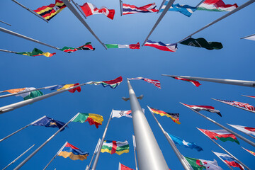 Various flags of the world against the blue sky.