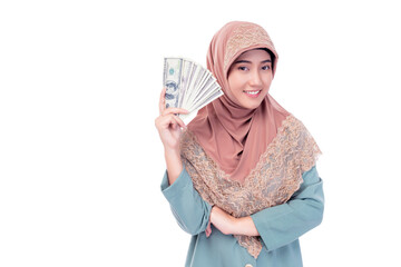 Smiling young Muslim woman in a headscarf proudly displays a fan of US dollar bills, representing financial success and empowerment. Muslim Investment Banking Financial and Economy concept