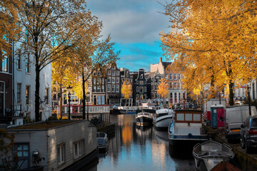 Facades of old historic Houses and trees over canal water, Amsterdam, Netherlands