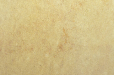 The aged appearance of the fabric background, with its visible stains and uneven coloration, suggests a long and eventful history.