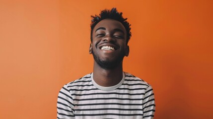 Fototapeta premium portrait of a black man on orange background