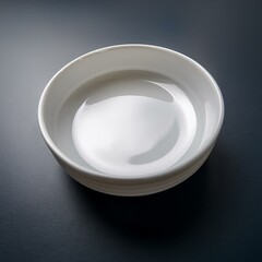 White ceramic bowl with a unique, rounded design. Perfect for serving dips, sauces, or small snacks.