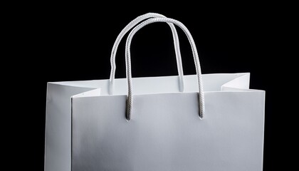White paper bag with handles, isolated on black background.