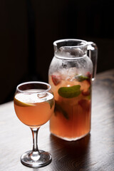 Cocktail in a glass with ice and mint on a wooden table