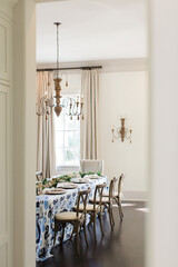 coastal dinner party with long table looking in from another room