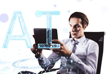 Businessman using a tablet with digital AI graphics overlay on a white background. Concept of technology and artificial intelligence