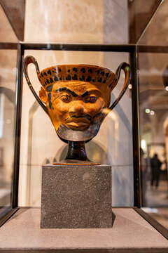 Paris, France - April 10, 2023: Ancient Greek kantharos - vase for drinking wine in shape of Satyr head from Louvre museum in Paris, France. It is a national art museum founded at 1793.